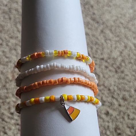 Handmade Halloween Stretch Bracelets. Four Bracelets Total. Colors Are White, Orange And Yellow With A Candy Corn Charm. Thanksgiving Seed Bead Bracelets, Fall Themed Bracelets, Beaded Bracelets Fall, Halloween Beaded Bracelet, Fall Bracelet Ideas, Halloween Bracelet Ideas, Candy Corn Jewelry, Seed Beaded Bracelets, Fall Sleepover