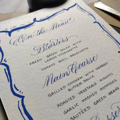 💠 Hand Written & Hand-painted menu design 💠 Classic | Simple | Vibrant Sharing more on this later today. ☁️✨😬💙 #handwritteninvites #handwrittenmenu #handwrittenmenus #blueink #cerulean #ceruleanblue #customink #handmade #sitdowndinner #tablesetup #calligraphymenu #illustratedmenu #menucards #menudesigns #menucarddesign #gouachpaints #illustration (Customized, menu cards, calligraphy, artist, Kolkata, hand drawn, illustration, gouache, dinner menu) Menu Card Design, Sauteed Green Beans, Calligraphy Artist, Lemon Vinaigrette, Garlic Mashed, Custom Ink, Table Set Up, Herb Butter, Hand Drawn Illustration