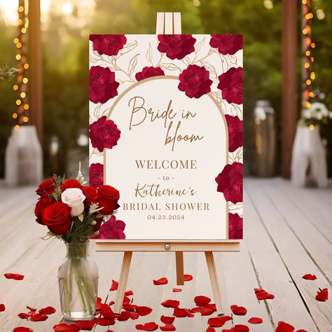 Bride in bloom theme bridal shower welcome sign features roses  in red and maroon color with gold floral and botanical pattern.A perfect gold and off white color background with red roses floral arrangement. Bridal Shower Ideas Burgundy, Black And Red Bridal Shower Ideas, Maroon Gold And White Wedding Decor, Red Themed Bridal Shower Ideas, Red Roses Bridal Shower Theme, Bridal Shower Ideas Red, Valentine Wedding Theme, Bridal Shower Red Theme, Red Bridal Shower Theme