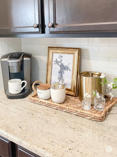 This coffee station is organized on a tray with a canister to hold k cups, a small canister for sugar and a small planter with stirs. I used a frame from Studio Mcgee and Target to cover up the cord to the coffee maker. Farmhouse Countertop Coffee Station, Coffee Station Apartment Small, Small Keurig Station, Studio Mcgee Coffee Bar, Small Coffee Bar In Kitchen, Keurig Coffee Station Small Office, K Cup Coffee Station, Tea Station Kitchen Countertops, Coffee Area Kitchen Counter