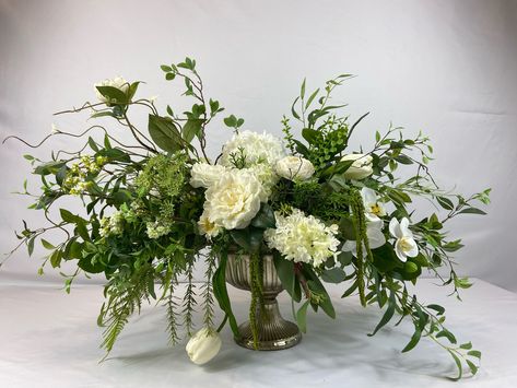 This is a natural white centerpiece filled with real touch roses, a large ranunculus bloom, orchid, and tulips. A large white hydrangea and hydrangea cones can be found mixed between the beautiful real touch blooms. A mix of lush different greenery and twigs have been uniquely designed around the blooms. The centerpiece has been designed on all sides and can be used all year around.  Length: 33 Inches, Width: 20 Inches, Height: 23 Inches (measurements are tip to tip) Thank you for viewing S&B Blumen Design shop. Please contact us with any questions. Ranunculus Centerpiece, Monochromatic Flowers, White Flower Arrangements, Green Centerpieces, Greenery Centerpiece, Hydrangea Centerpiece, Greenery Arrangements, White Centerpiece, White Hydrangea