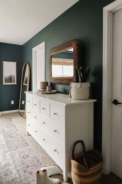 white dresser rattan mirror dark green walls Jasper By Sherwin Williams, Rock Garden Sherwin Williams, Rocky River Sherwin Williams, Jasper Sherwin Williams, Cascades Sherwin Williams, Sherwin Williams Jasper, Bedroom Maximalist, Plain Room, Vintage Inspired Rugs