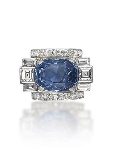 AN ART DECO SAPPHIRE AND DIAMOND RING The cushion-shaped sapphire flanked with square and baguette-cut diamonds, to the brilliant-cut diamond line detail, mounted in platinum, 1930s Art Deco Diamond Sapphire Ring, Diamond Sapphire Ring, Bijoux Art Deco, Sapphire And Diamond Ring, Jewelry Auction, John Hardy, Deco Jewelry, Blue Jewelry, Sapphire Jewelry