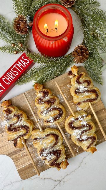 Kamry Vincent | Kentucky Creator on Instagram: "How cute are these Nutella Christmas Tree Pastries?!🎄They are so simple to make! Share this fun idea with a mama! 😊 Ingredients •2 Sheets of Puff Pastry •Nutella •Egg •Powdered Sugar •Skewers Directions 1)First, preheat oven to 400 degrees Fahrenheit. 2) Unroll puff pastry and spread on Nutella. 3)Lay the other sheet of puff pastry on top and then use a pizza roller to slice into long 1 inch wide strips. 4)Fold your strips of pastry into a Christmas tree and put skewer through the middle of the pastry. 5)Brush tops with egg wash. 6)Bake in oven for 15-20 minutes. 7)Sprinkle with powdered sugar and enjoy! —— #christmas #christmastreats #easyrecipe #momsofinstagram #christmasfood" Nutella Christmas Trees, Nutella Christmas Tree Puff Pastry, Nutella Christmas Tree, Nutella Christmas, Egg Wash, Crescent Rolls, A Pizza, Puff Pastry, Christmas Treats