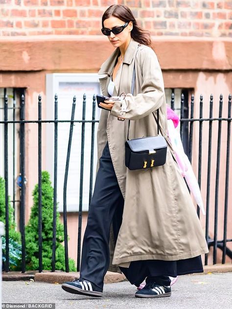 Irina Shayk keeps it casual with a trench coat and slacks as her daughter Lea, six, models Barbie pink in New York City | Daily Mail Online Irina Shayk Street Style, Trench Coat Outfit Fall, Feminine Era, Cute Feminine Outfits, Irina Shayk Style, Casual Trench Coat, White Slacks, Beige Trench Coat, Trench Coat Outfit