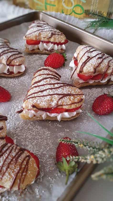 Strawberry cream puffs are delightful pastries filled with a luscious strawberry cream filling. Here's a description of these delectable treats: Pastry shells: The pastry shells are made from choux pastry, a light and airy dough that puffs up when baked. The dough is prepared by combining flour, butter, water, and sometimes eggs. It is then piped onto a baking sheet and baked until golden and crispy on the outside while remaining hollow on the inside. The result is a delicate and crispy shell Strawberry Cream Puffs, Fest Mad, Cute Baking, Strawberry Cream, Läcker Mat, حلويات صحية, Sweet Snacks Recipes, Whipping Cream, Think Food