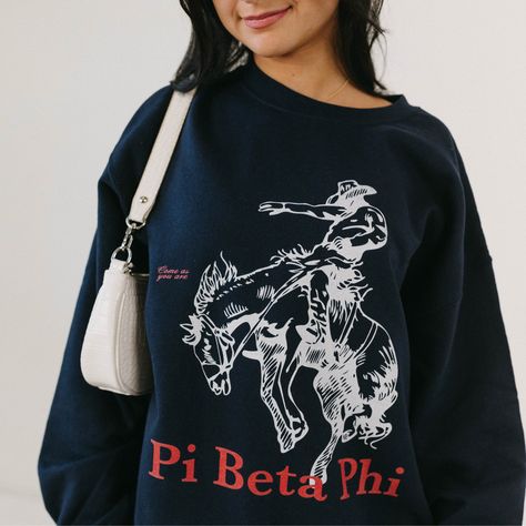 Navy crewneck, boyfriend fit. Our model is wearing size large (unisex). Size up for an oversized fit. 50% cotton, 50% polyester. Fraternity Letters Sweatshirts, Frat Merch Designs, Pi Phi Merch, Cute Sorority Merch, Sorority Pr Shirts, Trendy Sorority Apparel, Pi Beta Phi Graphic, Sorority Merch Apparel Design, Sorority Apparel Ideas