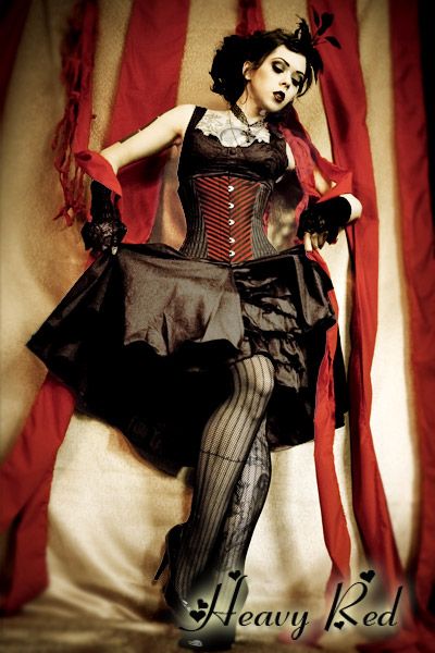 This is my next ensemble for Dorian's Parlor. It is exactly what I've been looking for -- dark, burlesque, sort of Wonderland-y in a non-obvious way. Heavy Red makes a version of this dress with a red and black underskirt. Now I just need to decide which version to get. Steampunk Circus, Burlesque Vintage, Gothic Type, Pierrot Clown, Dark Circus, Black Ruffle Dress, Gothic Steampunk, Vintage Circus, Gothic Dress