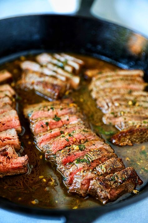 This Flank Steak Recipe is so easy and perfect for busy weeknights. An affordable flank steak is portioned and cooked quickly in a traditional cast iron pan and elevated to restaurant quality with a quick and delicious garlic butter sauce. Skillet Flank Steak, Flank Steak Recipes Oven, Flank Steak Oven, Flank Steak Recipe, Flank Steak Tacos, Marinated Skirt Steak, Cast Iron Steak, Steak Fajita Recipe, Roasted Potato Wedges