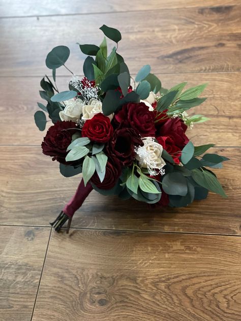 Sola wood flower bouquet with red  flowers. Preserved eucalyptus as well as artificial . Size pictured is medium. Bouquet  can also be made in small or large.MADE TO ORDER!! Each flower is hand made and painted so a slight variation in placement may occur from one bouquet to the next. Please allow 8-10 weeks for shipping. Can also add matching  bridesmaid bouquets boutonnieres and corsages per request ! Message me for custom orders For matching boutonnieres--> https://www.etsy.com/listing/740856 Eucalyptus And Red Roses, Bride Bouquets Red Roses, Homecoming Bouquets, Red White Bouquet, Red Floral Arrangements, Wood Flowers Wedding, Red Wedding Bouquet, Red Rose Bridal Bouquet, Medium Bouquet