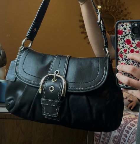 this is the black soho coach shoulder bag it has a buckle in the front and the sides. Black Satchel Bag Aesthetic, Black Y2k Purse, Cute Shoulder Bag Aesthetic, Coach Soho Shoulder Bag, 90s Designer Bags, Buckle Shoulder Bag, Vintage Black Coach Bag, Black Shoulder Bag Aesthetic, Vintage Coach Soho Bag