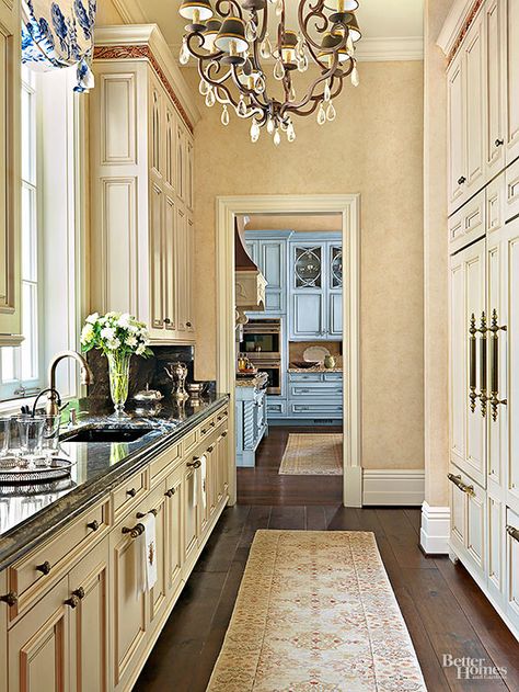 Distinguished from the kitchen by cabinet color the galley style butler's pantry maintains a refined look with custom cabinets and crystal chandelier. Butlers Pantry Ideas, Amazing Kitchens, Kitchen Butlers Pantry, Butler’s Pantry, Victorian Kitchen, White Kitchens, Butlers Pantry, Large Pantry, Marble Counter