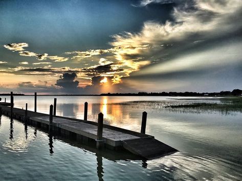 A calm lake at sunset.  The sky a wash with colors of blue orange and gold.  A dock in the foreground. Life In Paradise, Dock Of The Bay, Water Sunset, Otis Redding, Watching The Sunset, End Of Days, Airplane View, Photo Sharing, Paradise