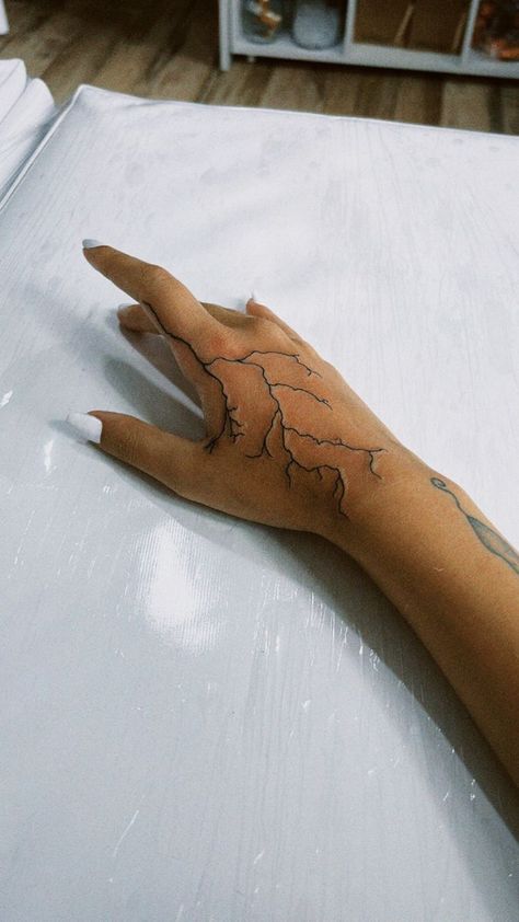 250+ Lightning Tattoos Ideas and Designs (2023) - TattoosBoyGirl Hand Tattoos For Guys Lightning, Lightning On Hand Tattoo, Lightning Tattoo Men Hand, Hand Lighting Tattoo, Hand Tattoos Lightning Bolt, Hand Tattoos For Women Lightning, Lightening Hand Tattoos, Arm Tattoo Lightning, Lighting Tattoo Arm Sleeve