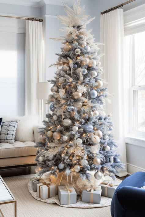 blue and silver Christmas decoration ideas including white christmas trees, blue ribbons, blue ornaments and more Flocked Tree Blue Ornaments, Christmas Tree Decor Blue And Silver, Blue Silver Christmas Tree Ideas, Christmas Blue And White Decorations, Xmas Tree White Decorations, Small Blue Christmas Tree, Navy White Silver Christmas Tree, Slate Blue Christmas Tree, Blue And Neutral Christmas Tree