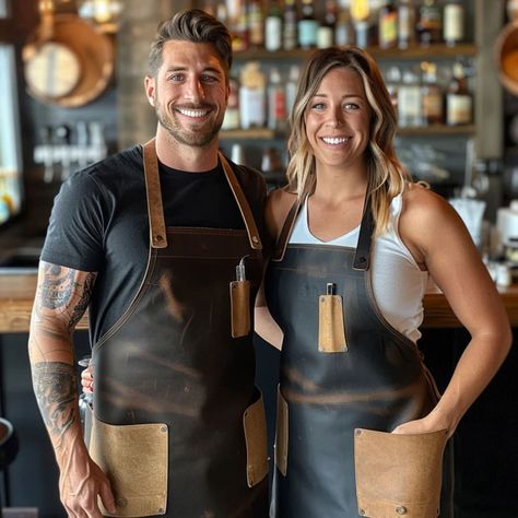 A couple wearing stylish leather aprons, perfect for bartenders or home entertaining. Durable and fashionable, these aprons add a touch of sophistication to any bar. Bartender Apron, Bar Apron, Barber Apron, Leather Apron, Bar Service, Leather Bar, Bar Styling, Professional Image, Functional Fashion