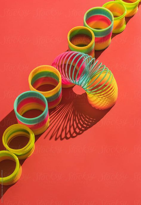 Colorful Slinky spring toy on colorful background. Slinky Toy, 80s Stuff, Figet Toys, Design Composition, 90s Toys, Plastic Toys, Anime Drawings Tutorials, Stock Photography Free, Toys Photography