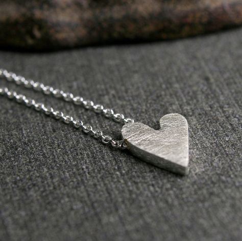 "Sterling silver handmade tiny dainty heart charm pendant necklace This is a truly tiny heart. A truly tiny heart doesn't mean you love any less...it just means you don't need to shout from the rooftops. It's a subtle sign that you are loved. Cut from a solid chunk of sterling silver it measures about 1/2\" long (1.25cm) and 1/4\" wide. This pendant is perfect for every day. A brushed finish adorns the front and my logo and sterling stamp grace the back. The chain travels through the pendant for Heart Pendant Necklace Silver, Simple Silver Jewelry, Sparkly Necklace, Silver Rings With Stones, Silver Jewelry Design, Silver Heart Pendant, Rustic Jewelry, Handmade Wire Jewelry, Charm Pendant Necklace