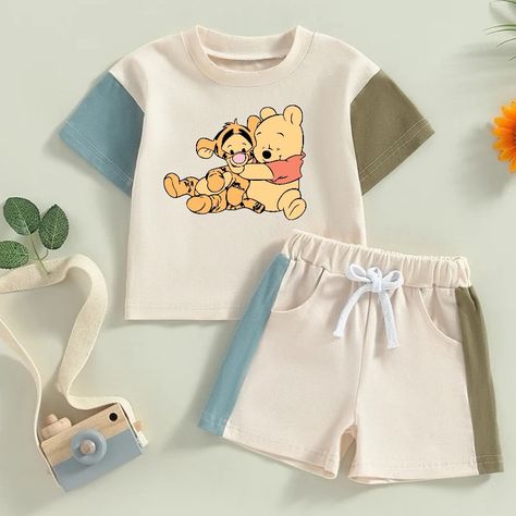 Adorable cotton color block toddler and baby outfit with cute Pooh and tigger print! 🥰 Our baby and toddler 100% cotton neutral outfit is the perfect combination of comfort and style for your little one.  Handmade from high-quality, natural cotton, this outfit is gentle on your baby's delicate skin and breathable for maximum comfort.  The neutral colors make it a versatile choice for any occasion, while the classic design ensures it will never go out of style.  Available in a range of sizes to fit your growing baby or toddler perfectly. Treat your little one to the best with our baby and toddler neutral 100% cotton outfit! Details: *Clothing is true to size.  *stretchy waistband *shorts and top *Very Soft breathable material. *Fabric cotton  *Machine wash cold & hang to dry to avoid shrin Cute Baby Outfits For Boys, Infant Outfits Boy, Boy Baby Clothes, Baby Clothes Boy, Girl Baby Clothes, Pooh And Tigger, Baby Boy T Shirt, Baby Boy Clothing