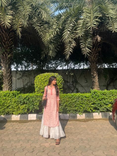 A girl wearing pink chicken kurti with white sharara standing in the sun. Chicken Sharara Suit, Chicken Clothes Kurti, Pink Kurti Aesthetic, Pink Kurti Outfit Aesthetic, Pink Chicken Kurti, White Plazo With Kurti, Short Kurti With Skirt, White Kurti Outfit, Pink Kurti Outfit