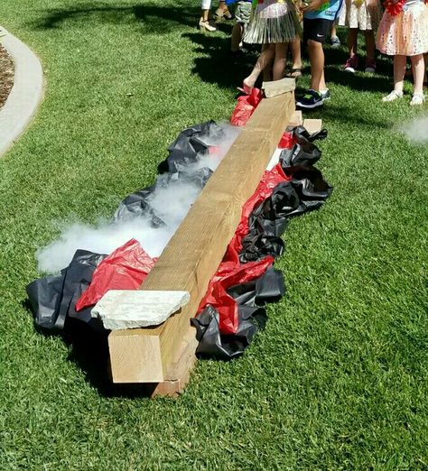 Moana birthday party theme decor or game: lava pit crossing. Wood on bricks, crumpled paper and dry ice. Great for luau game too! Floor Is Lava Trunk Or Treat, Floor Is Lava Birthday Party, Luau Party Ideas For Kids, Lava Party, Volcano Party, Volcano Birthday, Kids Luau Parties, Luau Games, Luau Party Ideas