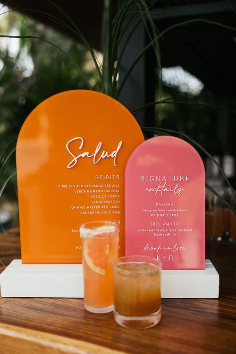 Pink and orange retro styled wedding signage beside cocktails Wedding Cocktail Ideas, Pallet Wedding Signs, Orange And Pink Wedding, Signature Cocktails Wedding, Bar Signage, Pallet Wedding, Cocktail Hour Wedding, Cocktail Ideas, Orange Retro