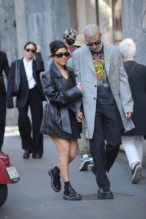 KOURTNEY Kardashian gave fans a sneak peek at her Met style as she walked hand-in-hand through Milan with fiance Travis Barker. The model and reality star looked like she wasn’t wearing any pants, as she toured the Italian city. Kourtney, 43 wore an extended black leatherish jacket – complete with matching tie belt. Travis, 46, went […] Kourtney Kardashion, Black Couple Outfits, 90s Girl Fashion, Kourtney Kardashian And Travis, Kourtney Kardashian Style, Italian City, Kardashian Outfit, Travis Barker, Kardashian Style