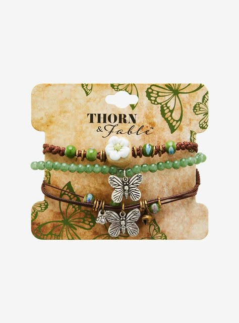 Flutter around sporting those grunge fairy vibes with this cord bracelet set! Includes a green beaded bracelet with a butterfly charm  and brown cord bracelets with earth-tone beads and flower and butterfly charms.Alloy; acrylic; cordAdjustableSet of 3Imported Beaded Braclets, Grunge Fairy, Flower And Butterfly, Green Beaded Bracelets, Fairy Grunge, Butterfly Flower, Funky Jewelry, Cord Bracelet, Butterfly Charm