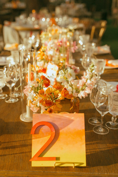 Sunset Inspired Wedding Reception Table With Watercolor Table Number #sunsetwedding #receptiontable #tablenumbers #watercolorwedding Sunset Wedding Tablescape, Bright Color Palette Wedding, Sunset Colors Wedding, Sunset Color Wedding, Diy Painted Table, Citrus Centerpieces, Sunset Inspired Wedding, Painted Table Numbers, Photo Seating Chart