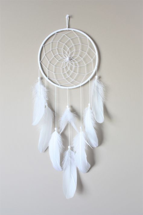 White Feather Dream Catcher with a web weave center.  It has lots of beautiful fluffy white goose feathers. This is a very simple yet elegant piece and would be the perfect addition to a boho style room or even make a great gift! CUSTOMIZE - we are happy to add a pop of color so please don't hesitate to ask questions. We carry a wide range of colored feathers.  Approximate Measurements:  Hoop: 7"  23" length Please hang away from direct sunlight. Cloud Dream Catcher, Teen Room Decor Small Rooms, Kids Dream Catcher, Simple Dreamcatcher, Dream Catcher Room Decor, Dream Catcher Ideas, Dream Catcher Small, Dream Catcher Painting, Boho Style Room