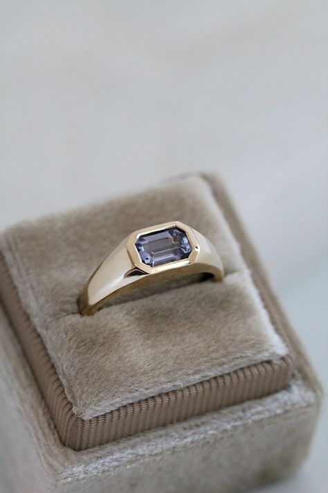 This yellow gold signet ring features a bezel set Emerald Cut Lilac Spinel, in east-west orientation. Perfectly showcasing the beautiful Spinel, this one of a kind ring could be worn as an alternative engagement ring, or simply as a cherished everyday ring. Set in 9ct yellow gold, the Emerald Cut Spinel is 0.94ct. The stone is approximately 7.1mm x 4.9mm. This ring is currently an Australian size L, and can be resized up or down. This ring is one of a kind. Once sold, it will be gone forever. Ho Simple Non Traditional Wedding Rings, Bezel Engagement Ring Emerald, Signet Engagement Rings, East West Engagement Ring, Ruby Ring Designs, Engagement Ring For Men, David Ring, Couple Ring Design, Engagement Rings Couple