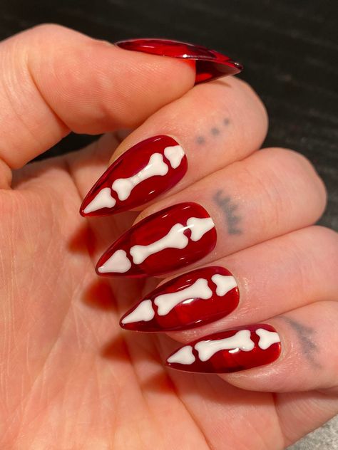 Hand painted press on nails with white bones over a sheer red jelly base. Shape pictured: STILETTO SHORT PLEASE READ: Use the nail sizing chart instructions from the photos to measure your nails. Then choose from the nail size options XS, S, M, or L. If your nails do not fit the standard sizes and you need custom sizing, please choose "CUSTOM" sizing and type in your custom sizes from thumb to pinky (ie. 1, 2, 3, 4, 5) under the "personalization" option. Please choose your length and shape. You Nail Art Designs Goth, Red And Black Halloween Nail Designs, Red 2000s Nails, Gothcore Nails, Halloween Nails Designs 2024, 80s Rock Nails, Short Alternative Nails, Halloween Nails Clown, Masculine Acrylic Nails