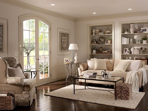 We love the look of lighter white walls with darker white trim. Add in neutral furniture and dark wood floors and you have a cozy living room space.  Walls: Cotton Knit UL170-13 Ceiling: Silky White UL170-12 Trim: Roman Plaster UL170-11 Alcoves inside: Parachute Silk UL160-16 Hallway Paint Colors, Behr Paint Colors, Bitter Chocolate, Behr Paint, Room Paint Colors, Mobil Home, Paint Colors For Living Room, Living Room Colors, Living Room Paint