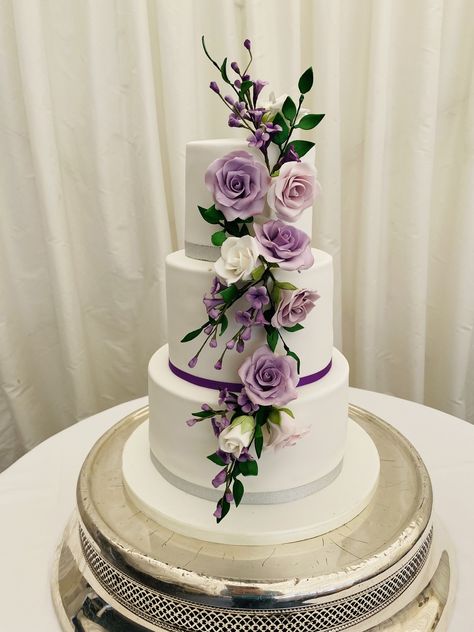 Roxi, 3 tier wedding cake with cascade of wired sugar lilac coloured roses with purple filler flowers Wedding Cake With Lilac Flowers, Lilac Wedding Cake, Wedding Cake Purple Flowers, Lilac Cake, Wedding Cakes Lilac, Light Purple Wedding, Coloured Roses, Lavender Wedding Cake, Ur Gay