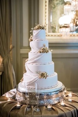 five-tiered wedding cake with fondant drapery and rope accents with golden flowers Ballroom Wedding Ceremony, Wedding Cake With Fondant, Elegant Ballroom Wedding, Elegant Ballroom, Cake With Gold, Golden Roses, Cake With Fondant, Cake Classes, Peonies And Hydrangeas