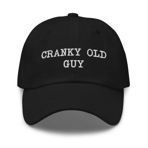 "This \"Cranky old guy\" funny quote is embroidered on adjustable Unisex Baseball Cap. This 100% cotton baseball hat is perfect for senior citizens. You'll be head over heels with this timeless piece! The funny hat comes in various colors to match your style and sits on your head just like a crown, thanks to the adjustable strap. * 100% chino cotton twill * Green Camo color is 35% chino cotton twill, 65% polyester * Unstructured, 6-panel, low-profile * 6 embroidered eyelets * 3 ⅛\" (7.6 cm) crow Funny Baseball Hat, Funny Baseball Caps, Retirement Gift Ideas, Men Embroidery, Embroider Ideas, Silly Hats, Funky Shirts, Matching Hats, Mens Hats Baseball