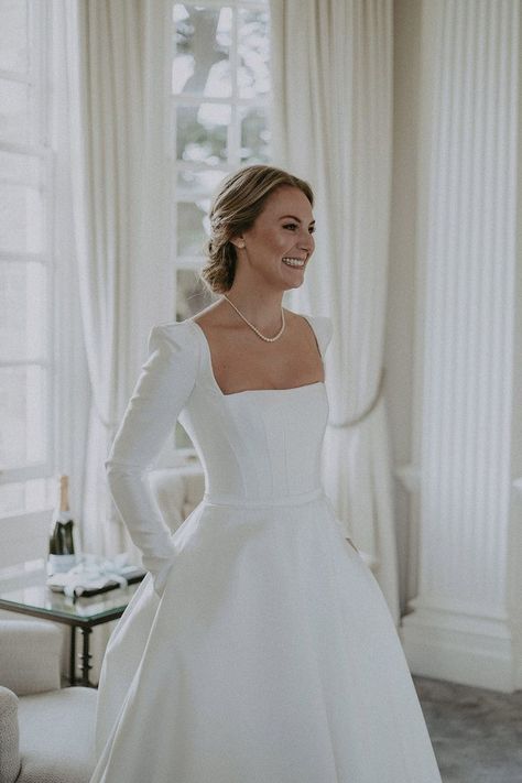 Bride wearing boned bodice square neck wedding dress with long sleeves, shoulder pads and pearl necklace and earrings Square Neck Wedding Dress, Hedsor House, Wedding Dress With Long Sleeves, Plain Wedding Dress, Pearl Wedding Dress, Neck Wedding Dress, Classy Wedding Dress, Boned Bodice, Minimalist Wedding Dresses