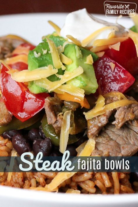 These Steak Fajita Bowls are like a fajita but in a tasty rice bowl. A perfect dinner made of tender steak and sautéed veggies over a bed of Spanish rice. #steakfajitabowls #steak #fajitas #mexican #rice #ricebowl #spanishrice #FavoriteFamilyRecipes #favf Fajita Bowl Recipe, Fajita Bowls, Rice And Beans, Steak Fajitas, Sauteed Veggies, Easy Family Meals, Rice Bowl, Beef Dishes, Quesadillas