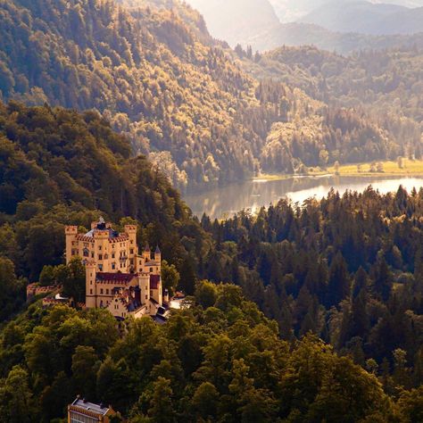 A trip to the Bavarian Alps will find the parental home of King Ludwig II nestled in 'The Valley of the Swans' - Hohenschwangau Castle. Overlooked by his famous Neuschwanstein Castle, Ludwig's parents restored and expanded the castle to its current splendor. It's said that King Maximilian, who adored his wife, decorated the castle with swans to symbolize the love between two people. What a charmer. Hohenschwangau Castle, Bavarian Alps, Germany Castles, Neuschwanstein Castle, Fairytale Fantasy, The Castle, Germany Travel, Swans, Two People