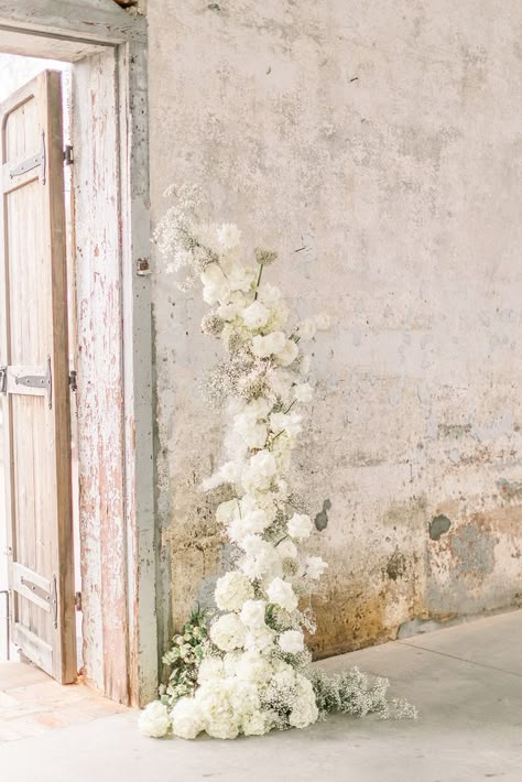 Foam Free Monochromatic All White Wedding Ceremony Floral Arch with hydrangeas, baby's breath, reflexed white Akito roses, ranunculus and allium All White Wedding Ceremony, Wedding Ceremony Floral Arch, Ceremony Floral Arch, Monochromatic Wedding, White Wedding Arch, Gypsophila Wedding, White Wedding Ceremony, Floral Archway, Floral Arch Wedding