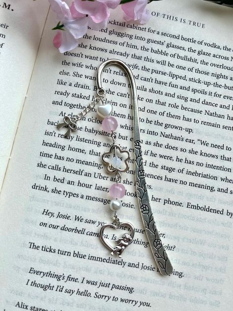 Handmade beaded bookmark featuring a coquette theme! Materials used include a silver metal bookmark hook, silver charms, and glass and plastic beads. Make your reading experience even cuter with this unique bookmark! ❀Canadian Customers- Standard default shipping ($2) *does not* include tracking as it is sent as untracked lettermail (via stamp). Upgraded shipping can be purchased at checkout, which includes tracking! Orders can take from 3-10+ business days to arrive if sent with standard shippi Bookmark Charms, Beads Bookmark, Bookmark Charm, Coquette Theme, Fun And Easy Diys, Silver Bookmark, Charm Bookmark, Heart Bookmark, Beaded Bookmarks