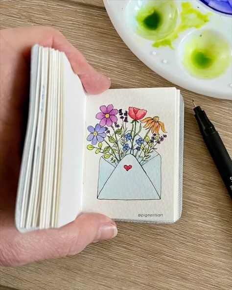 Pigments Art on Instagram: "For the love of flowers 🌷🌼🪻Swipe for photo 👉🏻  A simple ink drawing brought to life with watercolours. I’ve painted this in one of my Midi journals . Blank journals in various styles, colours and sizes are available on my website in a choice of genuine leather or faux leather covers. Link in my bio  . Pen: @stationery_island 0.5 fineliner Paint: Winsor and Newton Cotman  Brushes: @princetonbrush Journal: Pigments Art midi  . . . #travelsketchbook #artsupplies #artmaterials #artjournalsupplies #littleart #minipaintings #natureartwork #journals #journaling #pigmentsart #minijournal #artjournal #journallove #journalinspiration #journalinspo #journalart #journalcommunity #creativejournaling #handmadejournal #watercolorjournal #tinysketchbook #miniwatercolor #tr Pencil And Acrylic Art, Drawing With Colour Pens, Pen On Watercolor, Small Art Ideas Drawing, Simple Paint Pen Art, Coloured Pen Drawings, Mini Watercolor Painting, Sketch Pen Art Colour, Watercolour Brush Pen Art