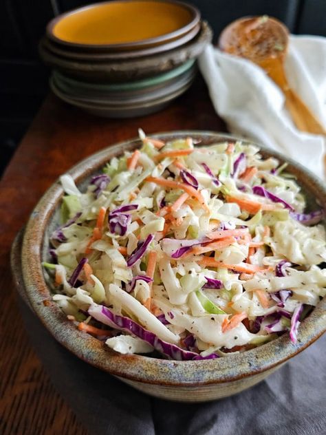 This Old Fashioned Creamy coleslaw recipe is full of classic charm and wholesome goodness. With shredded cabbage and carrot in a creamy, tangy dressing, this homemade coleslaw is deliciously satisfying. Vinegar Coleslaw Dressing, Old Fashioned Coleslaw Recipe, Sweet And Spicy Coleslaw, Coleslaw With Vinegar Dressing, Spicy Vinegar, Homemade Coleslaw Dressing, Spicy Coleslaw, Vinegar Coleslaw, Shredded Cabbage