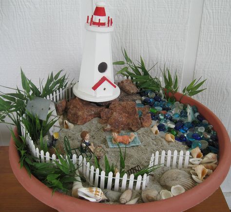 My own beach on the porch...Myrtle Beach sand and shells... Maine coast rock...Fairy Garden :) :)   made by Rita F...... Lighthouse Garden Ideas, Rock Fairy Garden, Beach Fairy Garden, Backyard Garden Landscape, Beach Garden, Miniature Gardens, Faeries Gardens, Mini Fairy Garden, Maine Coast