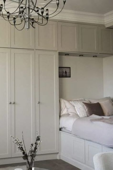 A studio flat with a wall-to-wall wardrobe extending over the bed Wardrobe Beside Bed Small Spaces, Wardrobe Design Around Bed, Wall Of Cabinets In Bedroom, Bed Along Wall, Built In Wardrobe Around Bed Ideas, Over Bed Built In Wardrobe, Ikea Pax Wardrobe Over Bed, Diy Bedroom Built Ins Around Bed, Small Bedroom Built In Wardrobe Around Bed