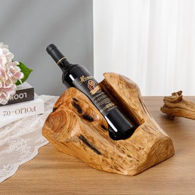 NATURAL AESTHETIC - A wonderfully unique wooden wine bottle holder, each one is hand carved from 100% natural root wood, sanded, and polished which gives it a beautiful rustic appearance. Perfect for those who wish to achieve a more natural decor style such as farmhouse or cottage Millwood Pines | Millwood Pines Archilla 1 Bottle Solid Wood Tabletop Wine Bottle Rack in 6.3 H x 15.0 W x 8.6 D in brownWood / Solid Wood in Natural | 6.3" H X 15" W X 8.6" D | Wayfair Wooden Wine Bottle Holder, Wood Wine Bottle Holder, Wine Stand, Barn Wood Crafts, Wine Sale, Wine Bottle Rack, Bottle Display, Wine Glass Rack, Vase Crafts