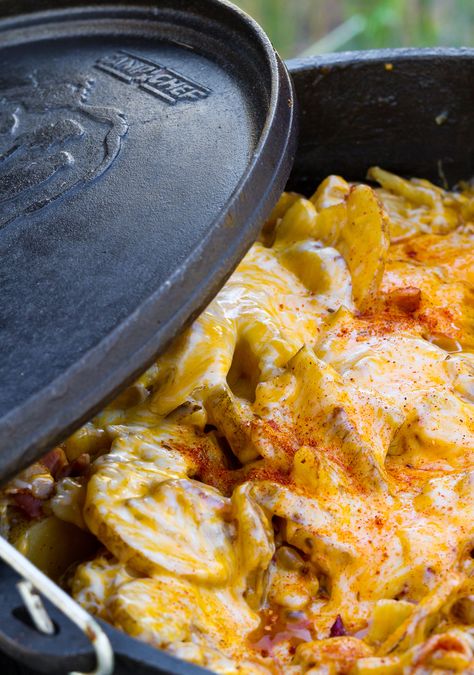 Easy Dutch Oven Potatoes | These potatoes are unbelievably delicious for how easy they are to make. After all, when the main ingredients are butter, cheese, bacon and potatoes, it’s pretty impossible to not create something delicious. | http://www.campchef.com/recipes/easy-dutch-oven-potatoes/ | Dutch Oven Potatoes, Oven Potatoes, Dutch Oven Camping Recipes, Dutch Oven Camping, Potatoes In Oven, Iron Skillet Recipes, Camping Sites, Dutch Oven Cooking, Dutch Oven Recipes