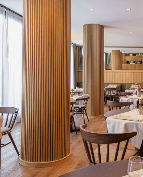 The columns in this modern restaurant's dining room have been wrapped in wood slats, hiding the column within, and turning a potential eyesore into a custom design accent. #RestaurantDesign #Columns #InteriorDesign Round Column Design, Interior Column Design, Column Design Interior, Pillar Design Interior, Column Decoration Ideas, Column Decor, Columns Interior, Column Cladding, Column Ideas