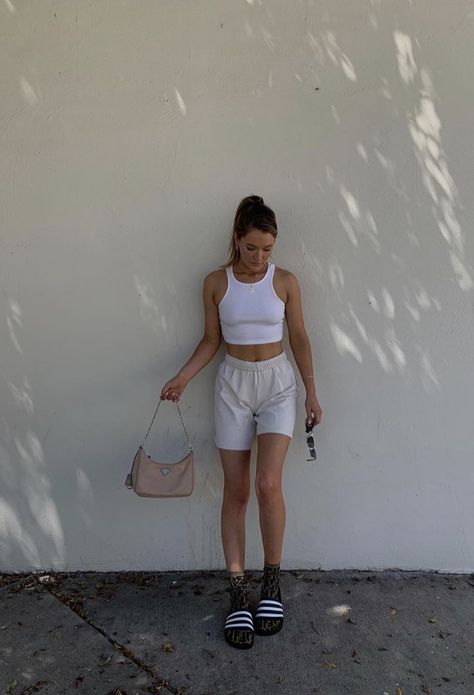 white halter tank top paired with grey or gray sweatshorts long socks and sandals or slide and a purse and sunglasses #accessories #purse #glasses #ponytail #lazy #chill laidback outfit. ponytail hairstyles.  Pink prada purse Gray Sweatshorts Outfit, Sweatshorts Outfits, Grey Shorts Outfit, Slides Outfit, Shorts Outfits Women, Model Outfit, Thrifted Outfits, 90s Fashion Outfits, Shorts Outfit