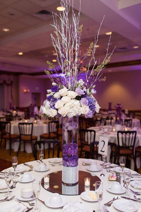 Tall Purple and Ivory Centerpieces With Sparkle Purple Black And Silver Centerpieces, Purple And Silver Dinner Party Decor, Lavender And Gold Centerpieces, Wedding Centerpieces Purple, Purple Flower Centerpieces, Engagement Event, Lavender Bridal Bouquet, Lavender Wedding Cake, Purple Wedding Centerpieces